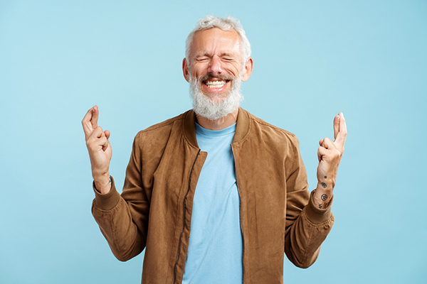 Investor with fingers crossed