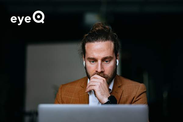 eyeQ image of man looking at laptop screen