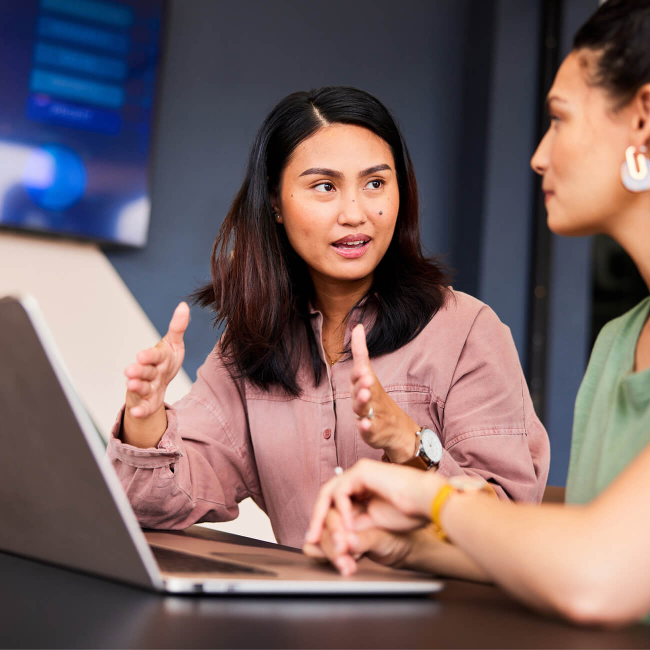 early careers woman in meeting explaining with laptop