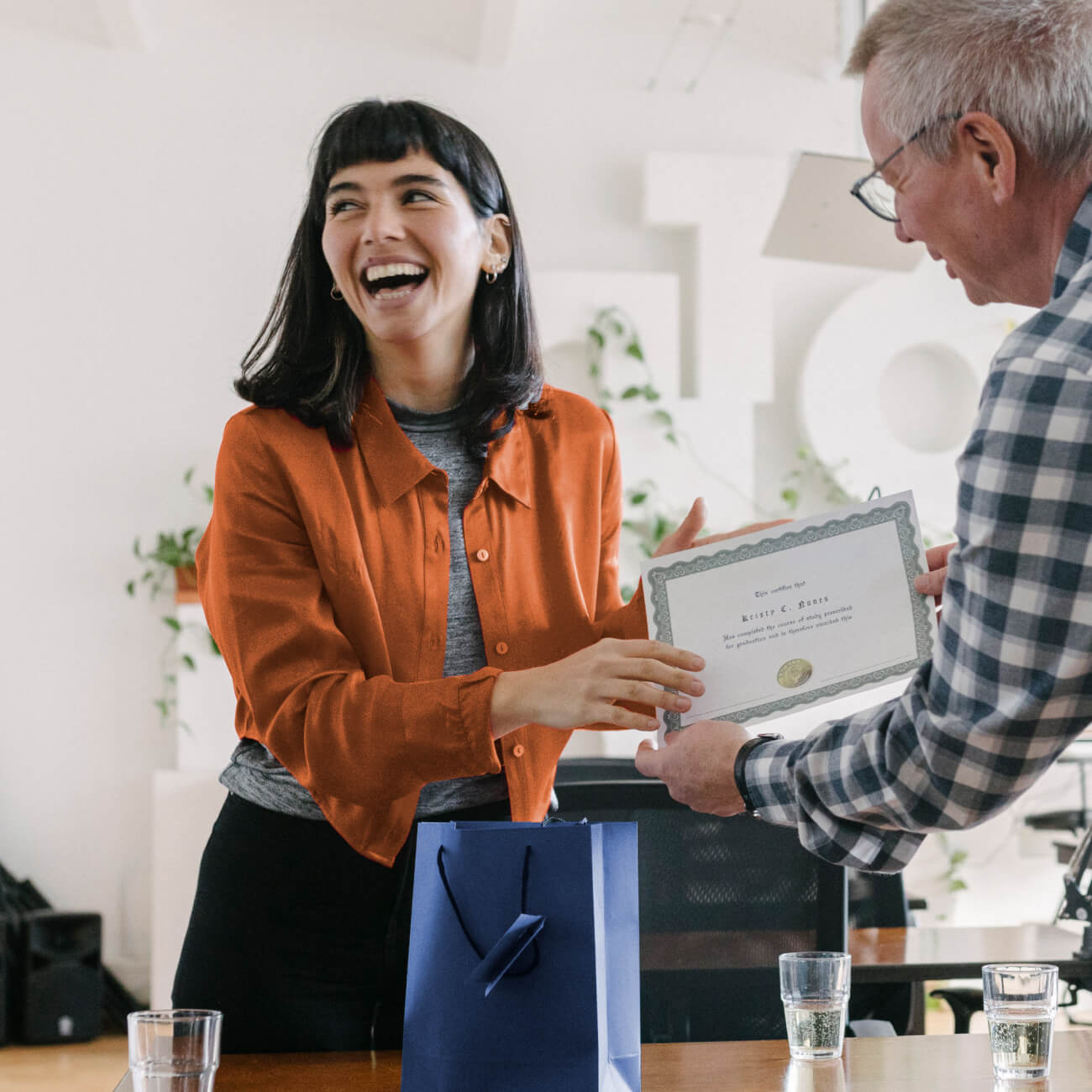 woman receiving certificate at work achievement happy